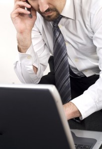 A man in suit and tie with his arms crossed.