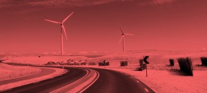 A road with wind turbines in the background.