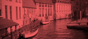 A red photo of two boats in the water.