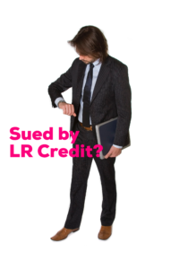 A man in suit and tie looking at his watch.